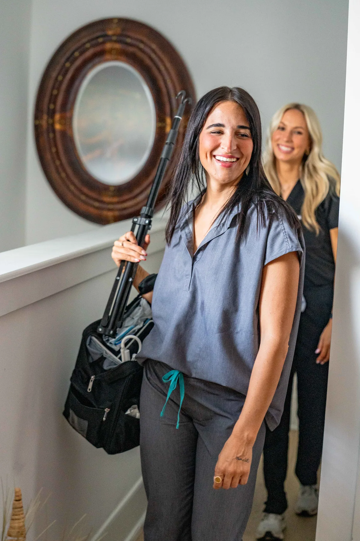 Drip Lab TN registered nurse with mobile IV gear in a Nashville rental entryway