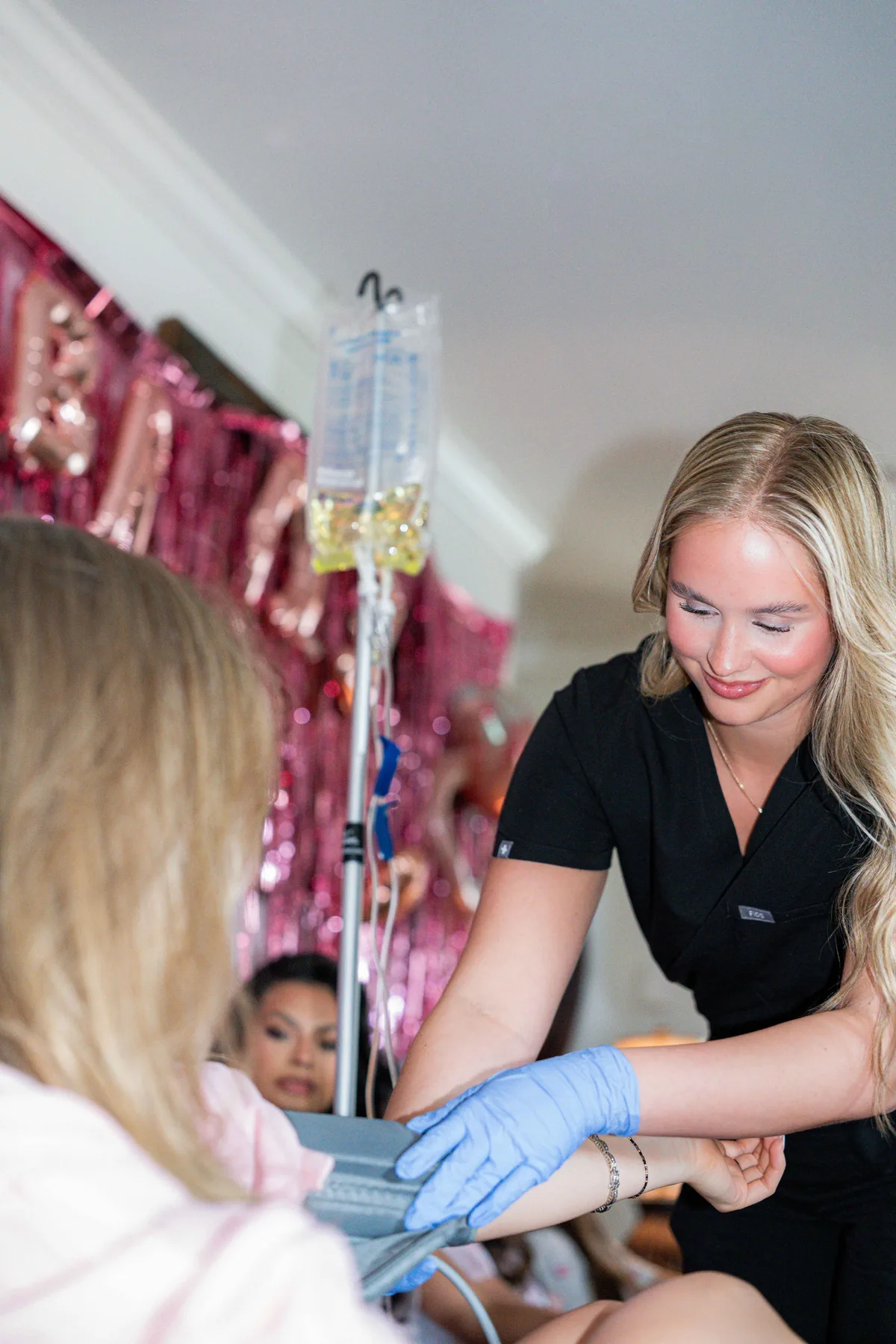 Drip Lab TN nurse taking a bride's blood pressure before her wedding-day IV in Nashville